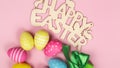 greeting card with text happy easter. multicolored easter eggs on pink background