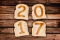 2017 greeting card toasted slices of bread on wood planks background