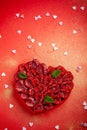 Greeting card with Valentine`s Day. confectionery Raspberry tart with mint in the form of a heart, lies on a red background Royalty Free Stock Photo