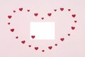 Greeting card for Valentines Day. Romantic composition with red paper hearts and a blank card on a pink background. Copy space, Royalty Free Stock Photo