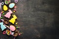 Greeting Easter Background. Easter gingerbread cookies and decorative colored eggs. On a brown background. Top view.