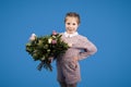 Greeting happy birthday. Glad caucasian little girl with bouquet of flowers enjoy spring