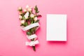 Greeting holiday card mockup with fresh roses on colored table background, mock up with copy space for design Royalty Free Stock Photo