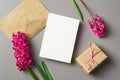 Greeting or invitation card stationary mockup with envelope, gift box and fresh hyacinth flowers on grey Royalty Free Stock Photo