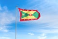 Grenada flag over blue sky background