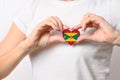 Grenada flag in the shape of a heart in the hands of a girl. Love Grenada.
