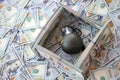 Grenade with a check against the background of huge amount of american dollar bills