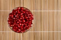 Grenadine seeds in glass bowl, upper view