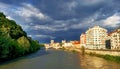 Dark clouds over the city. Sunny evening before a thunderstorm in Alps. Isere river, Grenoble, France Royalty Free Stock Photo