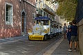 The Little Tourist Train of Grenoble in a small street