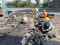 Gresik, Indonesia - Dec 9, 2021: Construction workers are repairing the paving stone road