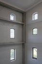 Grevesmuehlen, Germany, September 17, 2020: Corner in a tall former industrial building with white walls, at the top window hangs