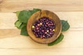 Grewia asiatica falsa fruit in wooden bowl top view on a wooden table background