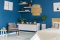 Grey armchair in blue bedroom Royalty Free Stock Photo