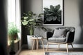 Grey armchair next to a wooden table in living room interior with plant and poster Royalty Free Stock Photo