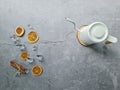 Grey background decorated with dried orange slices, cinnamon sticks and kettle on pine wood chip Royalty Free Stock Photo