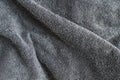 Grey background texture of Terry towel fabric, wavy folds Royalty Free Stock Photo