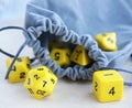 Grey bag, or pouch full of dices. Dices for rpg, board games, tabletop games or dungeons and dragons. Royalty Free Stock Photo