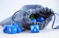 Grey bag, or pouch full of dices. Dices for rpg, board games, tabletop games or dungeons and dragons. Royalty Free Stock Photo