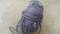 Grey ball of threads wool yarn for knitting on grey floor background Royalty Free Stock Photo