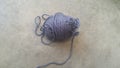 Grey ball of threads wool yarn for knitting on grey floor background Royalty Free Stock Photo