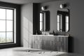 Grey bathroom interior with double sink and dresser with window Royalty Free Stock Photo