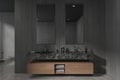 Grey bathroom interior with double sink and mirror, accessories in dresser