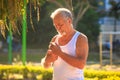 Grey Bearded Old Man in Vest Holds Water Bottle in Park Royalty Free Stock Photo