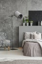 Grey bedroom interior with an elegant standing lamp with fabric