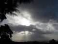 Grey sky with rays of sun and dark clouds Royalty Free Stock Photo