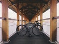 Grey-black fixie bicycle in the wooden path