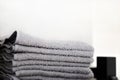 Grey towels towels are on the bathroom floor. Towels hung on hooks. Royalty Free Stock Photo