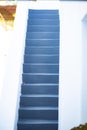 Grey stairs on a white balcony building