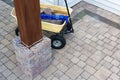 Grey bricks and a glue gun in a wheelbarrow