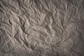 Grey-brown crumpled wrapping paper background, texture of grey wrinkled of old vintage paper, creases on the surface of gray paper Royalty Free Stock Photo