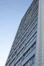 Grey building in city. High house. Windows in residential building