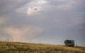 Grey bus on the meadow under the beautiful sky