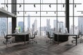 Grey business office interior with pc monitors in row, panoramic window