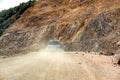 Off road mountain trail and car raising dust Royalty Free Stock Photo