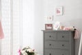 Grey chest of drawers in stylish room interior. Space for text Royalty Free Stock Photo