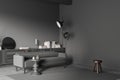 Grey chill room interior with couch and shelf, stool on carpet. Mockup wall