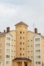 Grey chimney on a tiled with brick wall against a cloudy winter sky Royalty Free Stock Photo