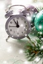 Grey Christmas alarm clock showing midnight, new years eve with decorations on white background