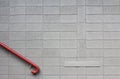 Grey cinder block wall with red hand rail Royalty Free Stock Photo