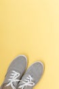 Grey classic sneakers on yellow background Royalty Free Stock Photo