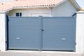 Grey closed door metal home gate at entrance of house suburb portal garden