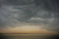 Grey clouds above orange sunset sea Royalty Free Stock Photo