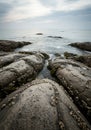 Grey Coastal Rocks and Calm Ocean Water Royalty Free Stock Photo