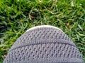Grey colored shoe on green grass background Royalty Free Stock Photo