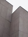 Grey concrete building with texture corners and sky